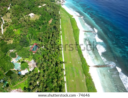 New version: A grass airfield on a Seychelles island, seen from the air, used for helicopters and light aircraft. Royalty-Free Stock Photo #74646