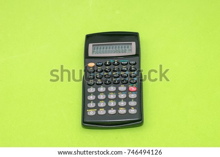 calculator isolated on green background. Office equipment for paperwork.