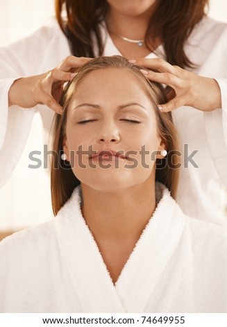 Closeup photo of masseur's hands, during head massage.?