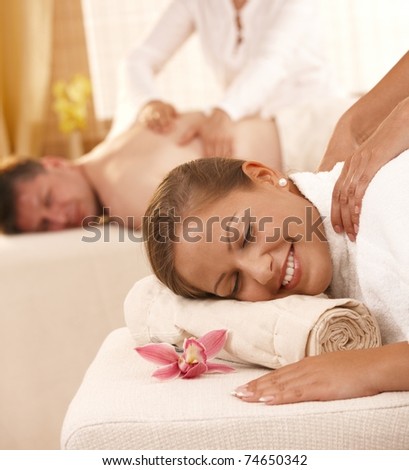 Closeup portrait of happy couple having back massage in day spa.?