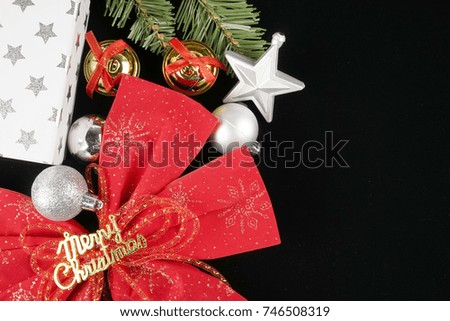 Christmas gift box and red ribbon on black background