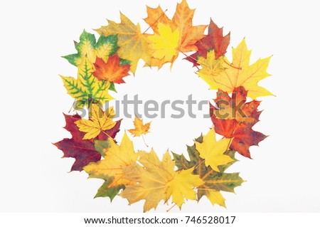 Autumn composition. Wreath made of autumn  colorful  leaves on white background. Flat lay, top view, copy space.