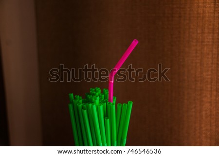 drinking straws on black background. Selective focus. Copy space. Colorful plastic drinking straws. straw for party cocktails. ==