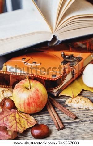 autumn still life, background for Thanksgiving or Halloween, colorful leaves and pumpkins, books and black tea, honey and biscuits, apples and chestnuts, warm atmosphere, wooden, fall