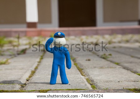Human clay figures. Society scene. Policeman. 