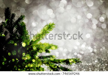 Fir-tree spruce branch with bokeh unfocused sparkles decor lights. Christmas new year year background template. Glow glitter background. Elegant abstract background with bokeh 