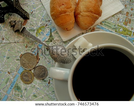 Paris theme. Symbols of France in flat layout or background. Cup of coffee with croissants, Eiffel tower, tea spoon with Napoleon,Paris map and old French coins. Vacation tour or journey to Europe