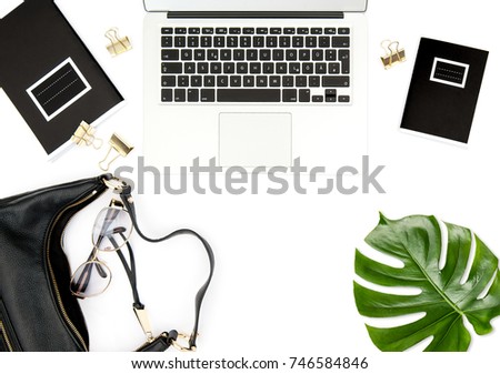 Office desk. Notebook, feminine accessories, green leaf on white background. Fashion flat lay for social media. 