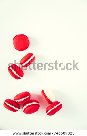 Red and white macarons on white background. View from above, copy space for text. 