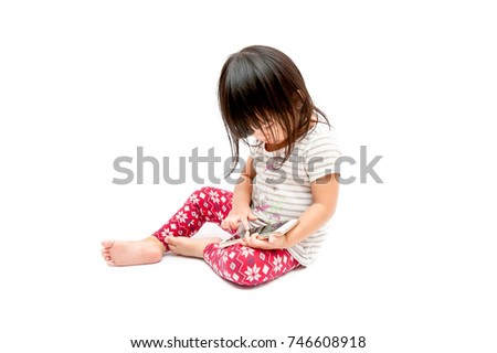 Little girl playing phone on white background.