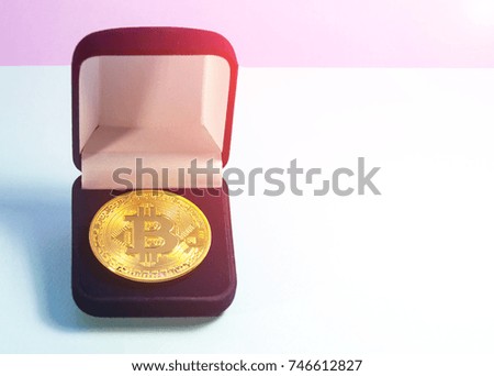 Coin bitcoin in a gift box for a ring or jewelry. The concept of crypto currency. The best gift for the holiday. A gift in Christmas. On blue background.