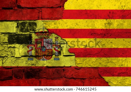 Flag of Spain and Catalonia on a textured brick wall