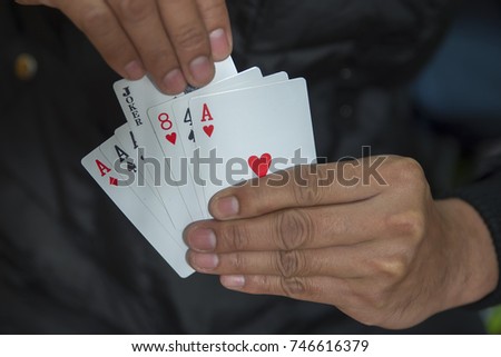 Man holding a Playing card