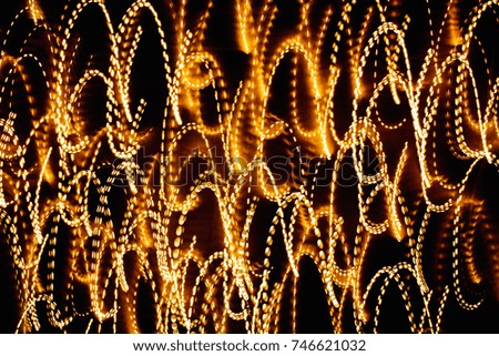 Abstract Bright Multicolored Glowing Lines and Curves on Black Background.