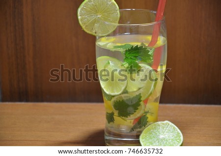 Mojito cocktail with lime and mint in highball glass on a wooden stone background Copy space