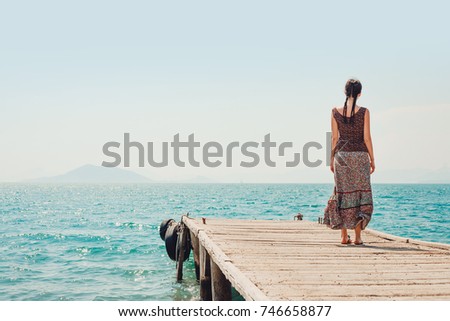 young beautiful woman on the pier with copy space