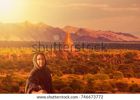 A Asian young man attractive backpacker tourist taking selfie photo and adventure on vacations route at the Temples of Bagan (Pagan), Mandalay, Myanmar. BURMA.