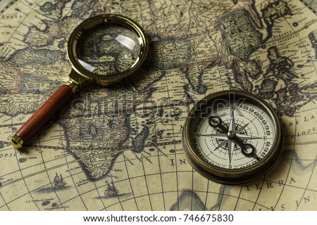 Retro compass with old map and magnifier Royalty-Free Stock Photo #746675830