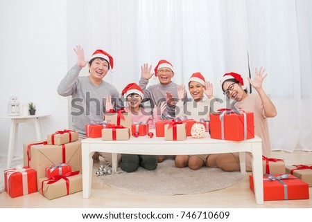 Portrait of Asian family in sofa giving presents for Christmas, asian family celebrate Christmas boxing day open the gift
