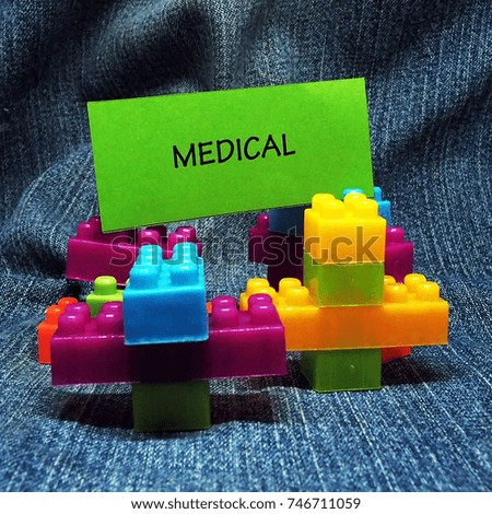 medical word with toys jeans background