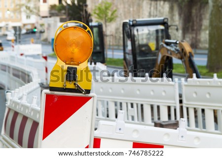 Orange construction Street barrier light on barricade. Road construction on the streets of European cities. Germany. Mainz.