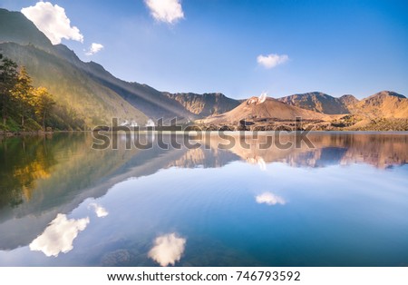 A beautiful view in the morning in front of Danau Segara Anak Lake with Baru Jari Mountain at the background. Rinjani Mountain, Lombok Indonesia. Soft focus due to long exposure