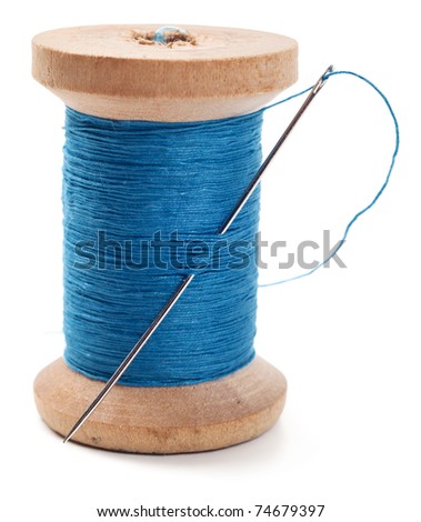 Spool of thread with needle isolated on white Royalty-Free Stock Photo #74679397