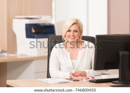 Portrait Of A Cheerful Casual Businesswoman Smiling