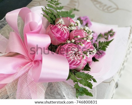 Creative bouquet of pink lotus in pink paper with a pink ribbon. Sweet and romantic color theme, a bunch of flower for a special occasion like birthday, valentines, anniversary, congratulations & etc.