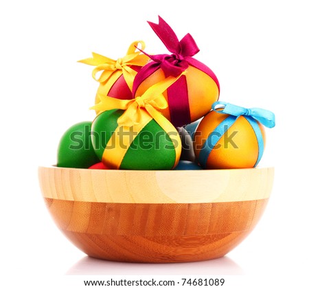 Easter eggs in wooden bowl isolated on white