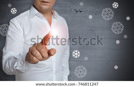 Snowflakes concept touchscreen is operated by man.