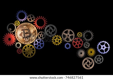Glowing golden bitcoin and path of colorful cog wheels on black background with copy space