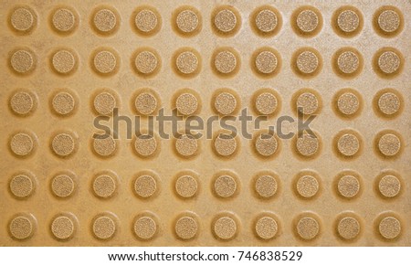 Yellow dot pattern of braille block paving slabs, Blind safety on pavement, Texture background