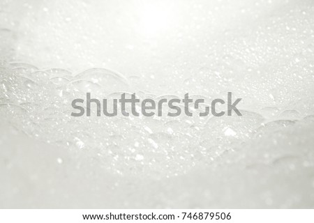 Abstract background white bubbles foam from washing powder. Health care, Hygiene concept. Laundry. Texture. Copy space. Royalty-Free Stock Photo #746879506