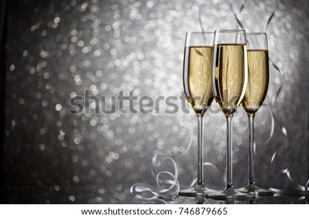 Photo of three glasses with wine on gray background