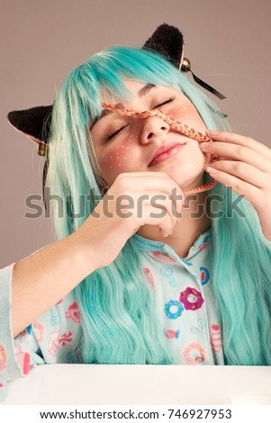 Portrait of a girl in cartoon style with blue hair and cat's ears with a snake on her face