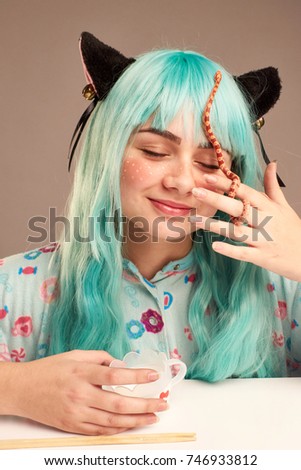 Portrait of a girl in cartoon style with blue hair and cat's ears with a snake on her face