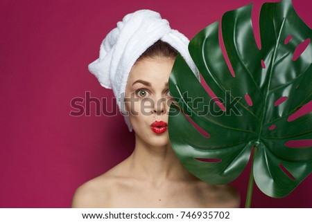 surprised woman with a towel full of lips with red lips on a black background, beauty, spa                               