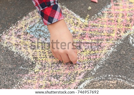 Little child drawing car with chalk on asphalt, closeup