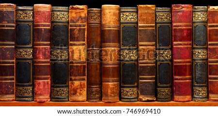 Ancient books on shelf in the library  Royalty-Free Stock Photo #746969410