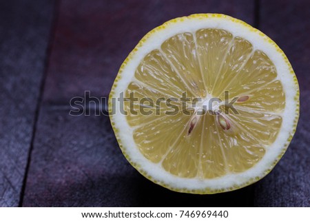 Lemon cut open on mahogany wooden background.