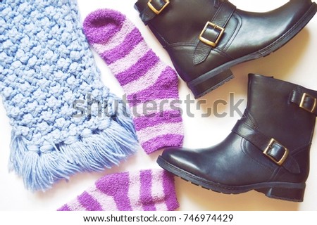 Blue scarf, purple socks and boots. Autumn and winter women's shoes and accessories. Flat lay composition. Top view stock photo