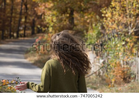 Young woman with long hair in Autumn nature