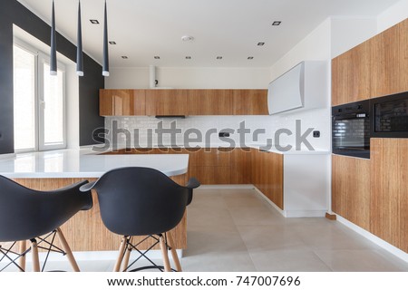 Contemporary kitchen in classical style with loft details. Luxury apartment downtown. Breakfast zone in comfortable brand new apartment.  Royalty-Free Stock Photo #747007696