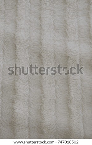 White warm blanket on a bed