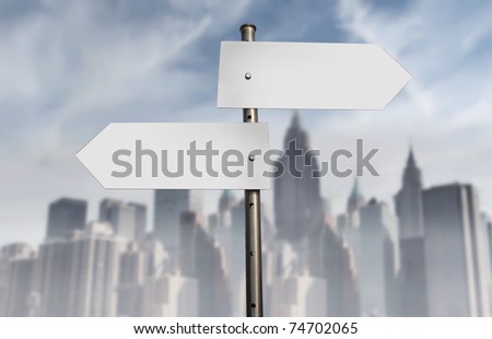 Road signs with cityscape in the background