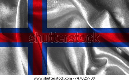 Realistic flag of Faroe Islands on the wavy surface of fabric. This flag can be used in design.