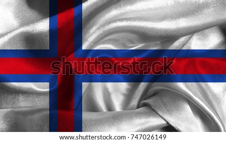 Realistic flag of Faroe Islands on the wavy surface of fabric. This flag can be used in design.