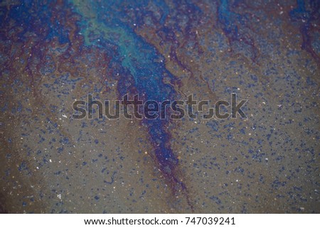 Abstract colours.Background texture of an oil spill on asphalt road