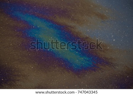 Abstract colours.Background texture of an oil spill on asphalt road

